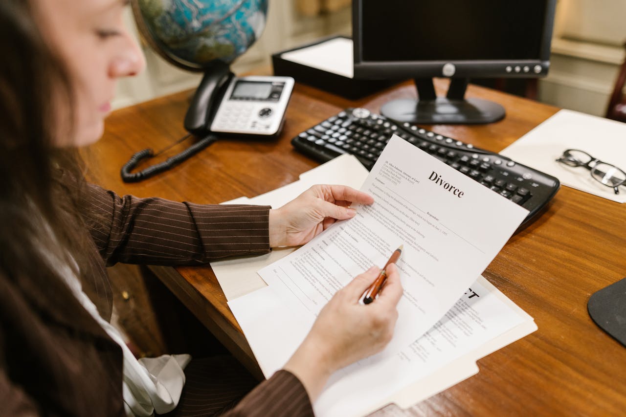 our-story-02 A lawyer examines divorce documents at a desk in a law office setting, emphasizing professionalism.